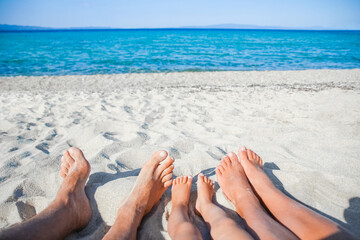 A feet of a happy family near the seashore in nature weekend travel