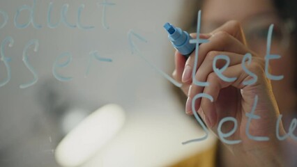 Thinks Business Analyst draws a diagram of a business plan on a transparent glass board. business data analyst uses colored markers to sketch business diagram with modern technology
 - Powered by Adobe