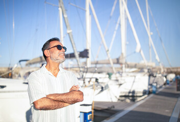 Relaxed Mature Man On Vacation Posing Near Yachts Outside