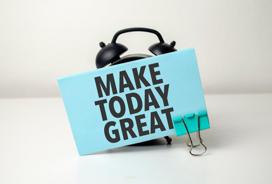 make today great is written in a blue sticker near a black alarm clock