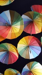 Looking up to the hanged multicolored umbrellas at the top of the street