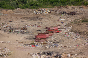 Industrial landscape, photo from above, orange rusty dumpsters in a landfill, garbage valley, dump in a quarry