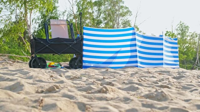 Privacy Screen Windbreak Windscreen Deployed on Seaside Beach on Summer Sunny Day