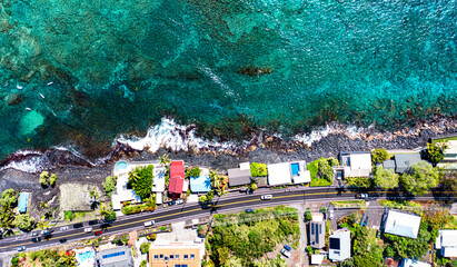 Coastal Charm: Aerial Glimpse of Homes, Reef, and Rocky Coastline in Kona, Hawaii