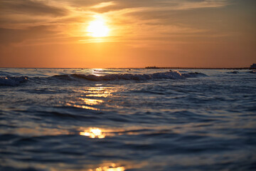 Orange-gold sunset, sky, sunlight, summer mood landscape with sea sunset on beach.