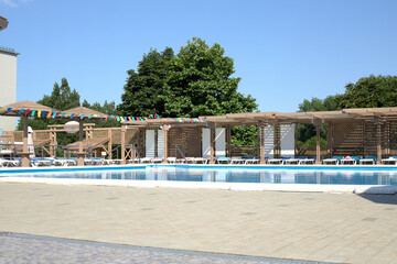 Holiday resort near the pool, sun umbrellas.