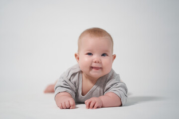 Fototapeta premium smiling baby looks at operator