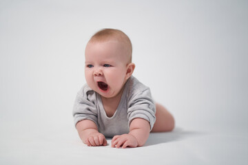 Yawning baby on a light background photo