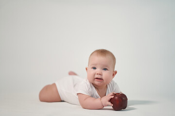Newborn baby with red apple