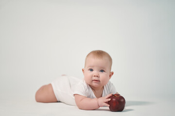 Newborn baby with red apple