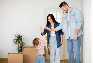 Happy Parents Giving Hight Five To Their Adorable Son On Moving Day