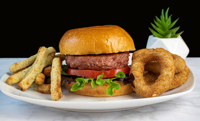 plant based  burger with veggie fries and  veggie onion rings