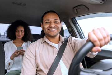 Cheerful Driver Guy Posing At Wheel Driving Auto With Passenger