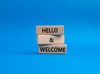 Hello and Welcome symbol. Concept words Hello and Welcome on wooden blocks. Beautiful blue background. Business and Hello and Welcome concept. Copy space.