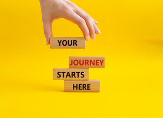 Your Journey starts here symbol. Concept word. Your Journey starts here on wooden blocks. Beautiful yellow background. Businessman hand. Business and Your Journey starts here concept. Copy space