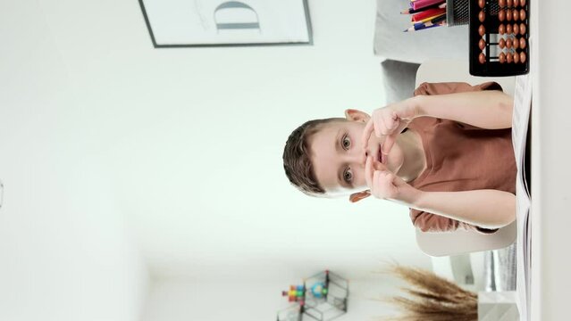 Little preschooler counting large numbers on his fingers using mental arithmetic, concept of child development.