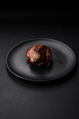 Delicious beef steak with salt, spices and herbs on a ceramic plate