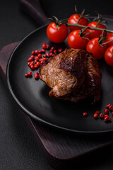 Delicious beef steak with salt, spices and herbs on a ceramic plate