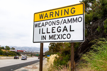 Sign on 5 freeway in San Diego warning that it is illegal to carry weapons or ammuntion into Mexico