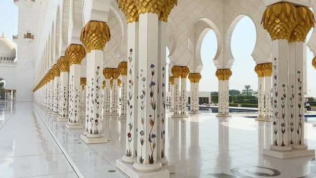 Abu dhabi, UAE - 3rd october, 2022: close up flowers on columns art exterior details on Grand mosque. Corridors of Grand mosque with nobody in bright sun light