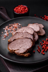Delicious beef steak with salt, spices and herbs on a ceramic plate