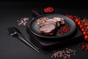 Delicious beef steak with salt, spices and herbs on a ceramic plate