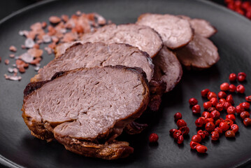 Delicious beef steak with salt, spices and herbs on a ceramic plate