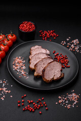 Delicious beef steak with salt, spices and herbs on a ceramic plate
