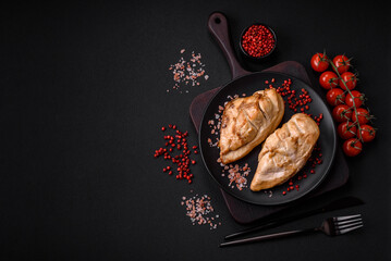 Delicious fresh grilled chicken fillet with salt, spices and herbs on a ceramic plate