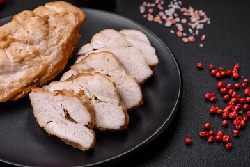 Delicious fresh grilled chicken fillet with salt, spices and herbs on a ceramic plate