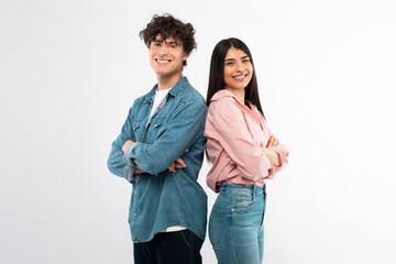 Cheerful Young Couple Crossing Hands In Confident Gesture, White Background