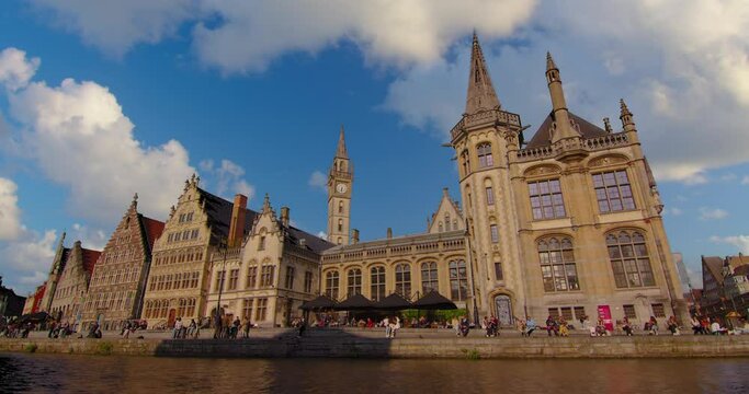 Wide shot of the city of Gent. Famous the cities landscape and historic landmarks. Establishing shot of old houses, streets and river in the city of Ghent on a sunny day, Belgium