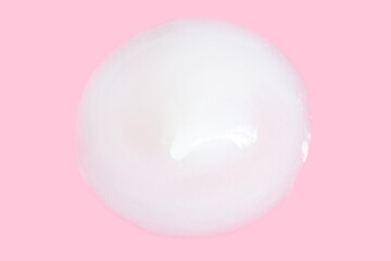 A smear of greasy melting cream. On a pink background.