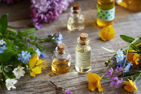 Aromatherapy essential oil bottles with spring flowers