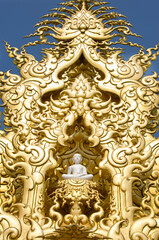 Fototapeta na wymiar Detailed golden Buddha statue, with frame in White Temple. Thailand Chiang Rai - Wat Rong Khun