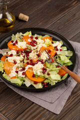Salad with persimmon and pomegranate