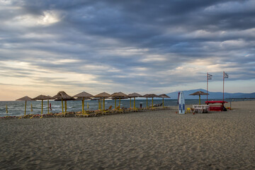 dramatic sky and the beach with umbrellas