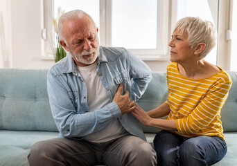 Senior woman comforting man at home
