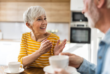 Senior couple drinking coffee at home
