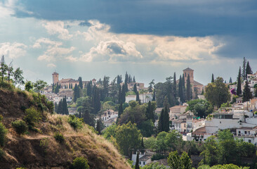 Views over Albaicín, Granada. The picture portrays a captivating evening scene with an approaching thunderstorm