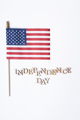 Independence day text with USA flag top view, flat lay on white background