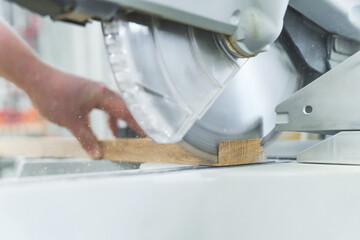 Electric circular saw cutting wooden plank in a carpentry workshop - Slow-motion. High quality photo