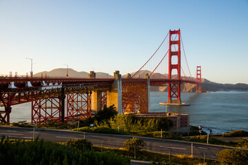 Fototapeta na wymiar View of Golden Gate Bridge with a blue sky, lit by sunset. San Francisco Bay area.
