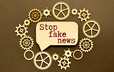 stop fakes - two red buttons on laptop keyboard. finger tries to press stop fake buttons on a gray laptop.