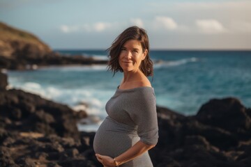 Fototapeta na wymiar Beautiful pregnant woman on the seashore. Pregnancy concept