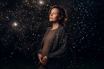 Medium shot portrait photography of a pleased pregnant woman in her 30s that is wearing a trendy jumpsuit against a meteor shower or night sky background . Generative AI
