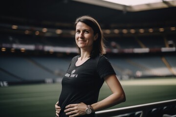 Fototapeta premium Portrait of a beautiful sportswoman in black t-shirt at the stadium