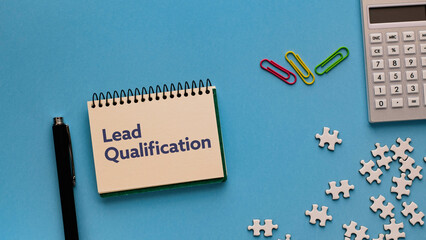 There is notebook with the word Lead qualification. It is as an eye-catching image.