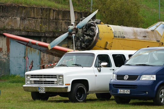 FINOWFURT, GERMANY - MAY 06, 2023: The full-size pickup truck Chevrolet Silverado C10, a modern VW Transporter against the background of the Soviet aircraft Antonov An-2. Race festival 2023.