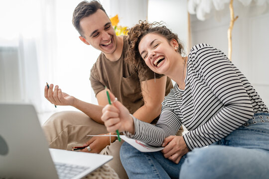 young couple man and woman having online class learn to draw on laptop